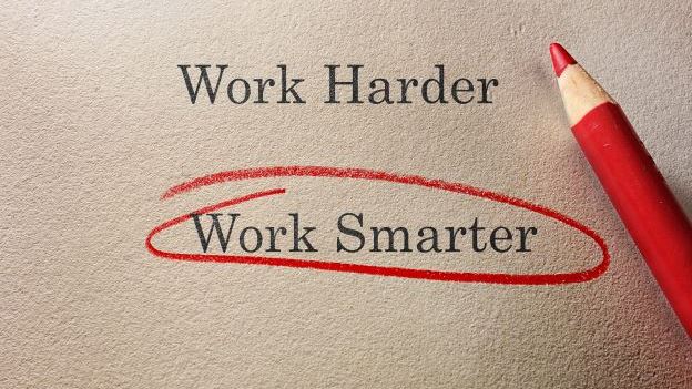 The words 'work smarter' highlighted in red pencil on paper