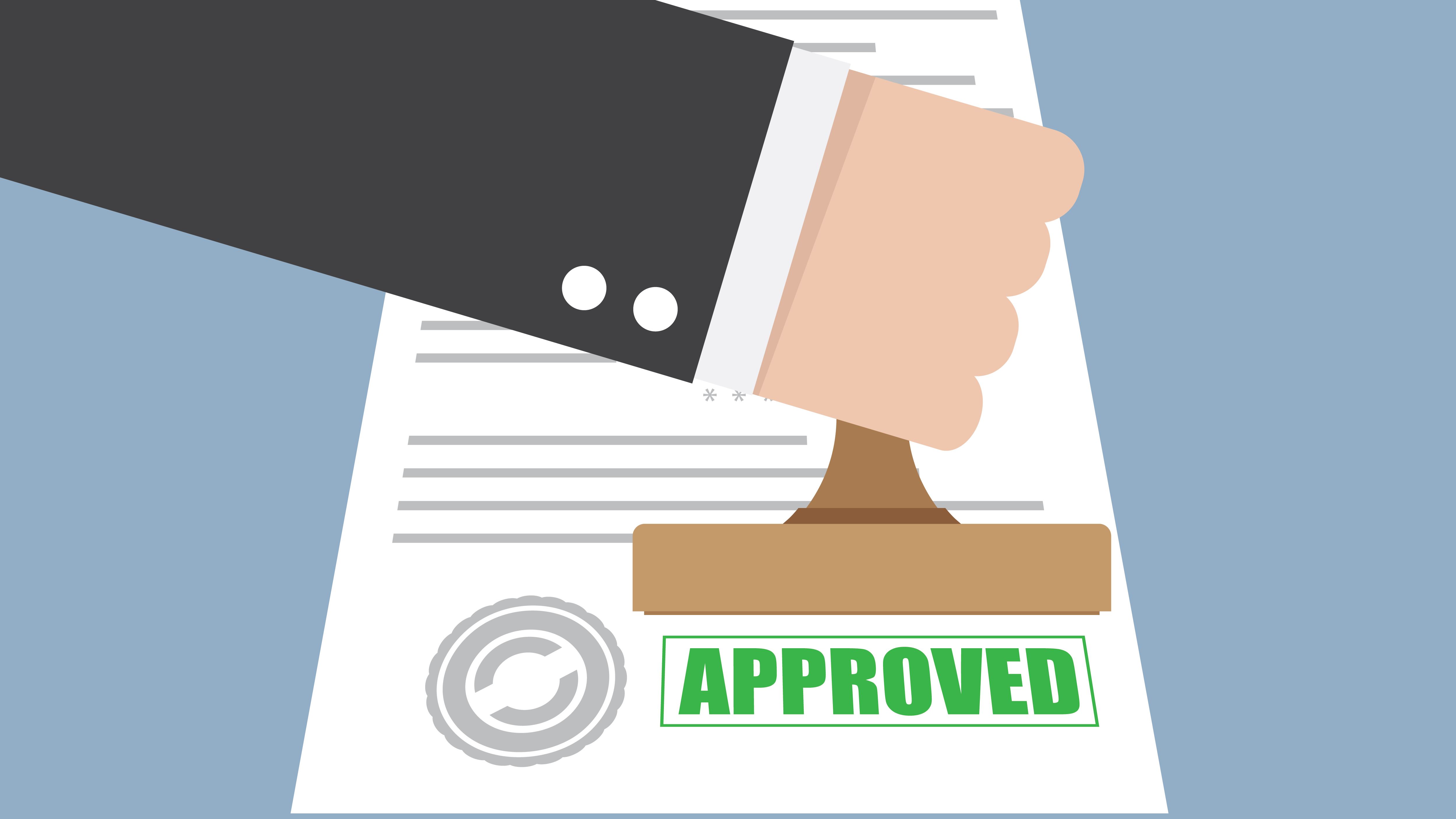 person stamping a document with the word 'Approved'