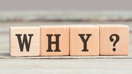 3 wooden blocks spelling out the words 'why'
