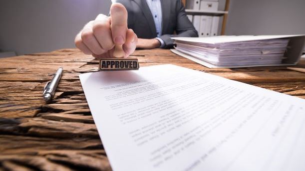 Close-up Of An HMRC Inspector Approving An R&D Tax Credit Claim