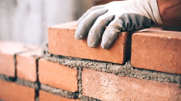 Builder laying a brick