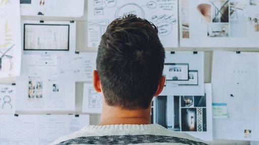 Image of a man looking at a plan board