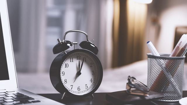 A clock sat on the desk of an R&D tax advisor