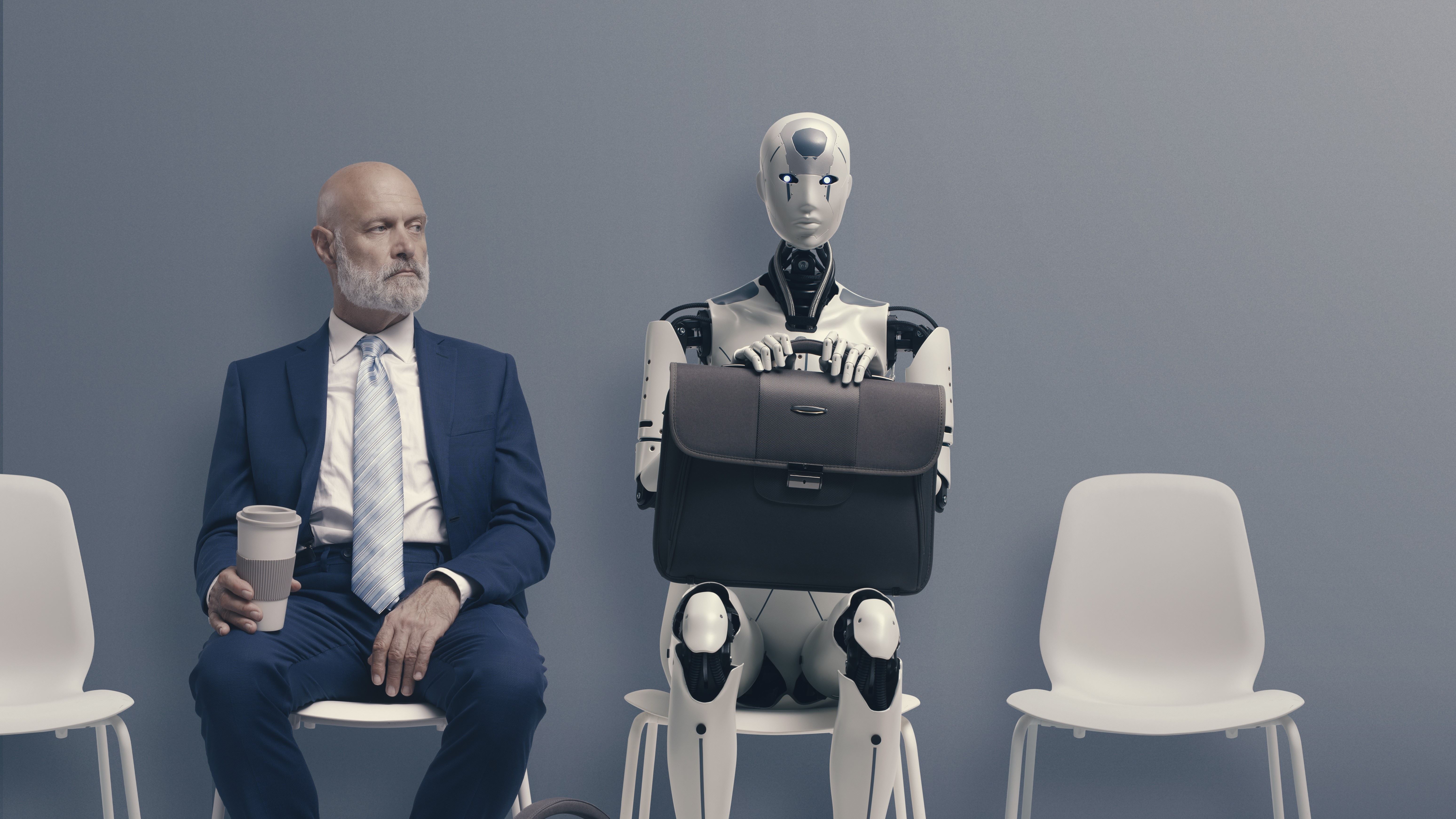 Human man in suit sat next to AI robot with briefcase