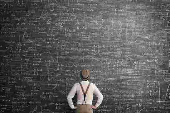 Person looking at blackboard with mathematical equations