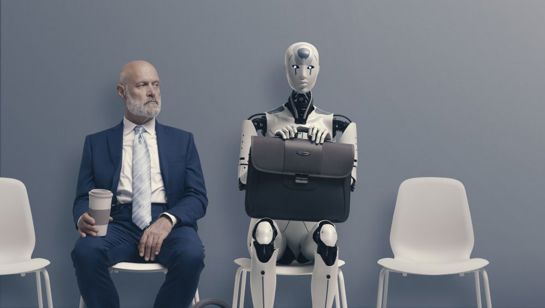 Human Man In Suit Sat Next To AI Robot With Briefcase