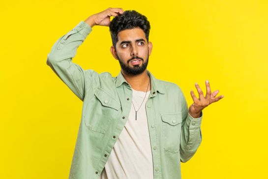 Person with confused expression on yellow background
